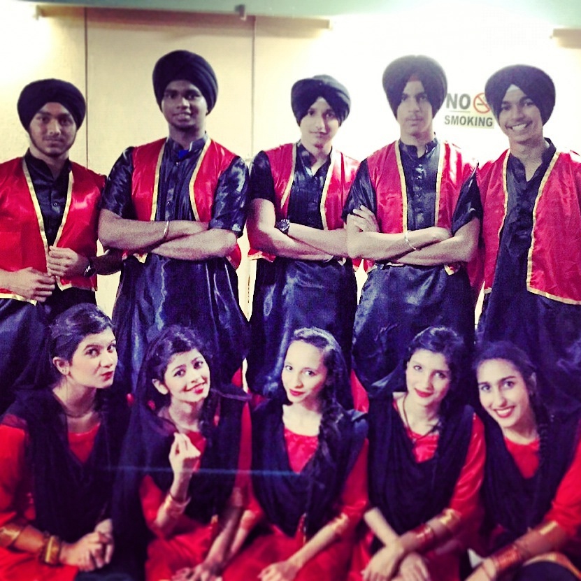 A group performs bhangra and garba, traditional Punjabi folk dances with colorful costumes.